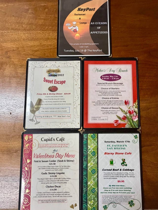 Five seasonal menus laid out on a table: an appetizer evening at the KeyPort, a New Year&rsquo;s Eve prime rib dinner, a Mother&rsquo;s Day brunch, a Valentine&rsquo;s Day menu and a St Patrick&rsquo;s Day corned beef special